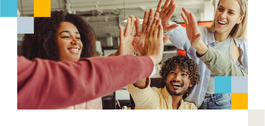 Diverse team sharing a high-five, celebrating success and social cohesion.
