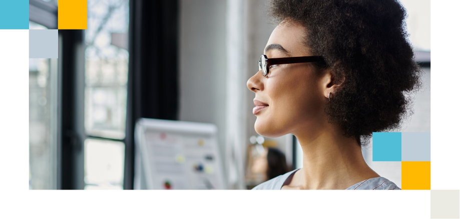 Profile of a professional with glasses looking ahead in a bright office, reflecting on next steps.